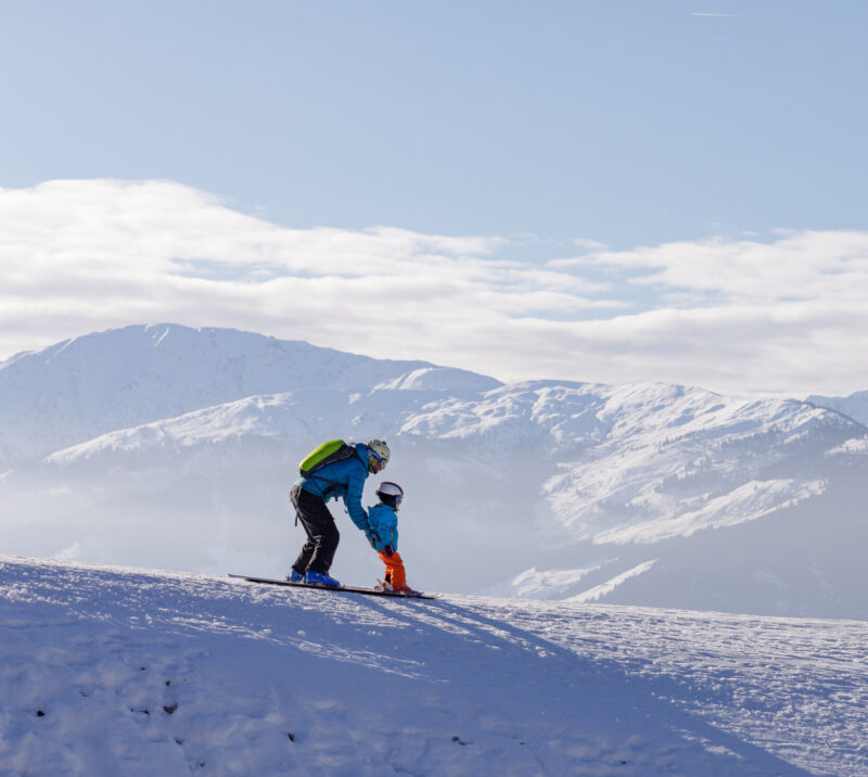 children skiing and snowboarding in the mountains, ski resort